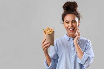 Happy woman with fast food french fries