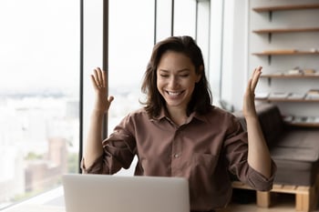 happy woman worker using laptop and excited