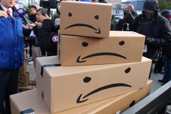 Amazon packages turned upside down with frowny faces