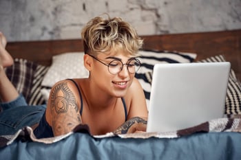 Woman using a laptop in bed