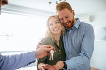 Couples receiving keys to their home