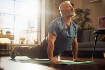 A senior man does yoga.