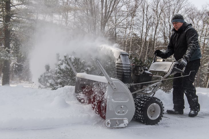 Man with snow blower