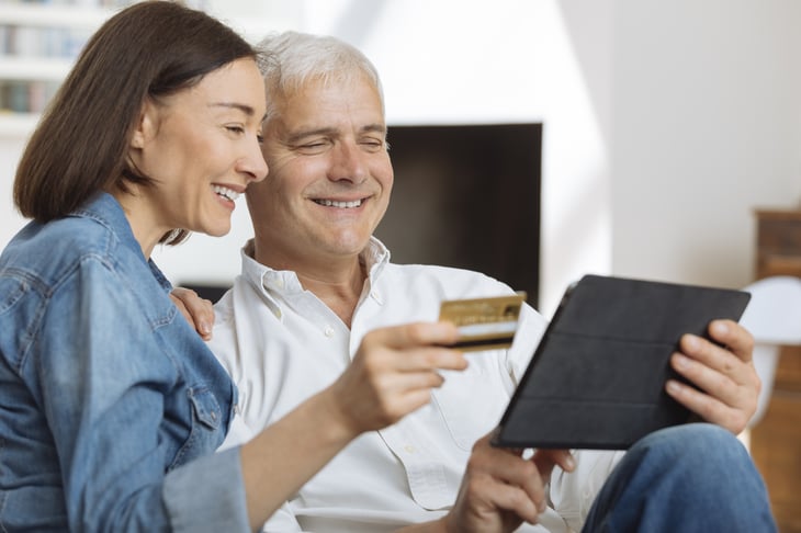 Mature couple using credit card