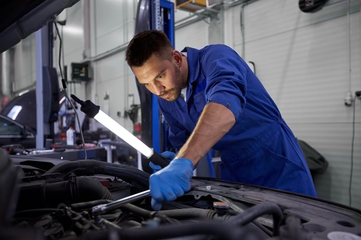 Auto mechanic working on a car