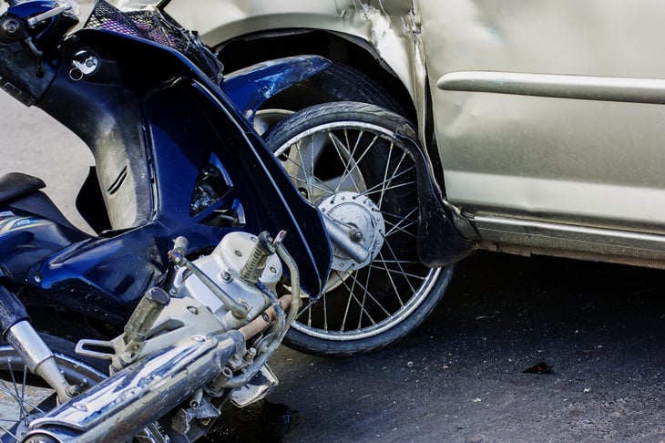 Motorcycle in collision with car.