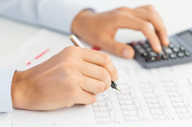 Hands with calculator and paperwork