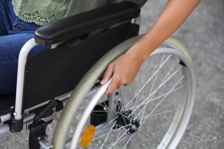 A woman uses a wheelchair