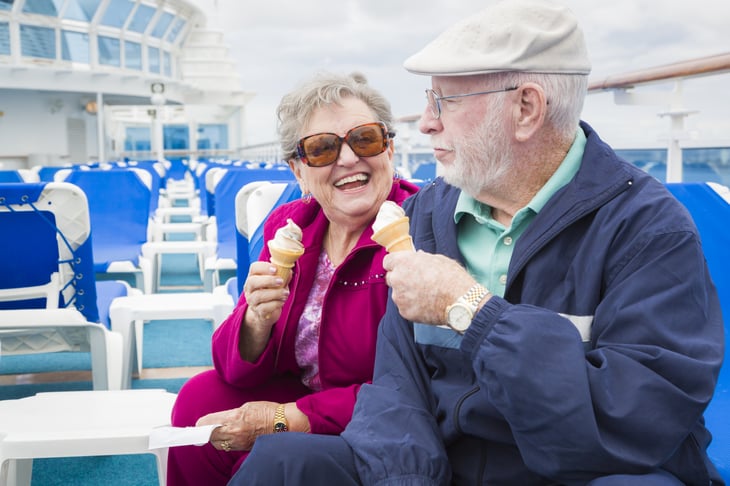 A couple eats ice cream on a cruise ship deck
