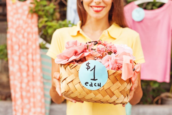 A woman sells items at a yard sale