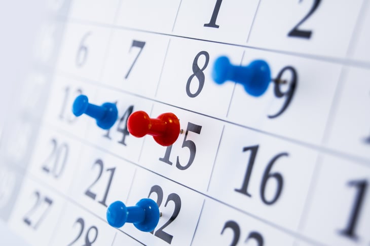 Dates are marked on a calendar with thumb tacks