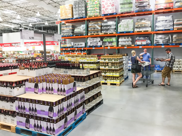 Shoppers talk in the wine aisle of a Costco warehouse club