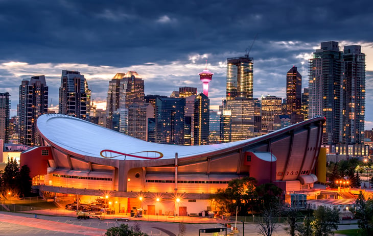 Nighttime view of Calgary, with Saddledome in the foreground