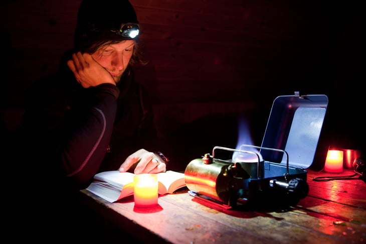 Man reading by headlamp