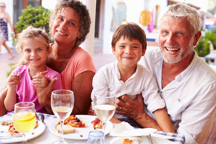 Grandparents eating at a restaurant with their grandchildren