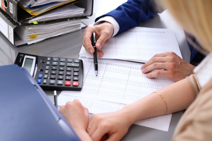 A woman works on her taxes with an accountant