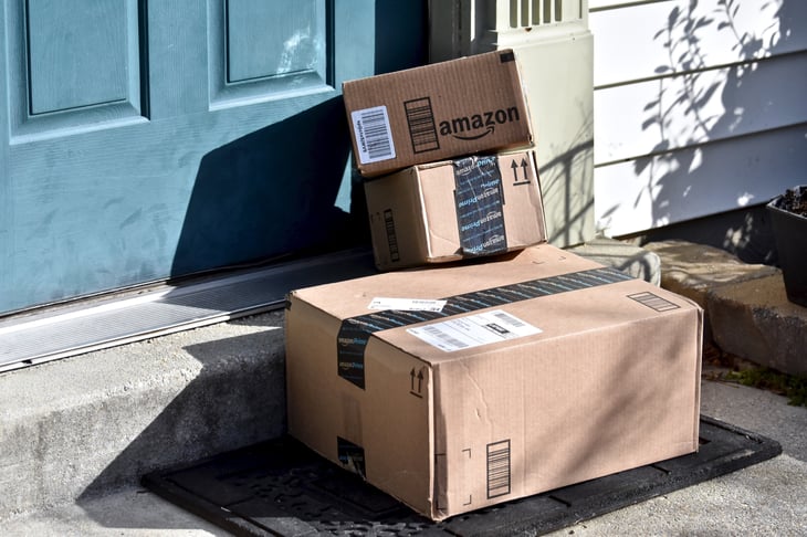 Amazon boxes seen piled up on a doorstep