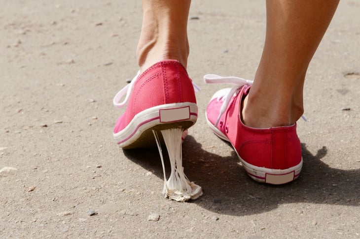 Tennis shoe with gum on the heel.