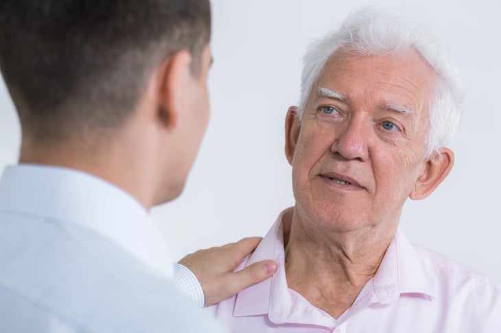 Man talking with elderly father.