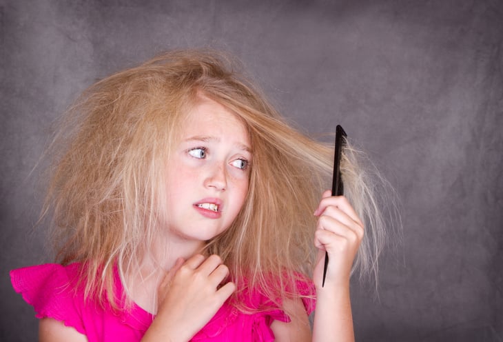 Girl with tangled hair and a comb