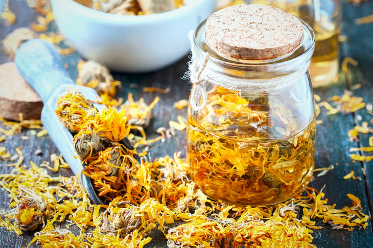 Yellow calendula flowers in a jar.