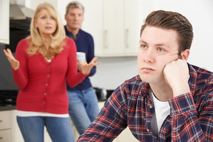 An adult millennial child living at home with his parents