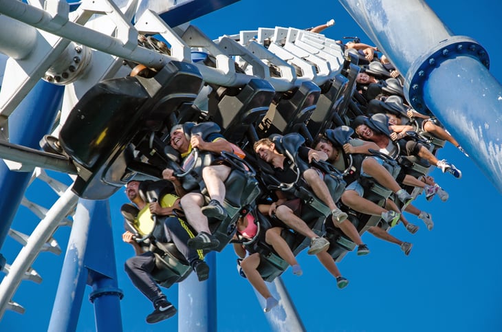 People upside down on amusement park ride.