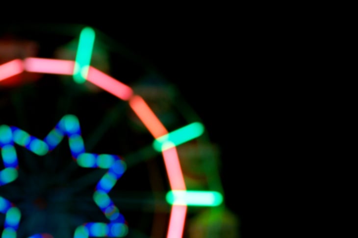 Blur of amusement park lights at night.