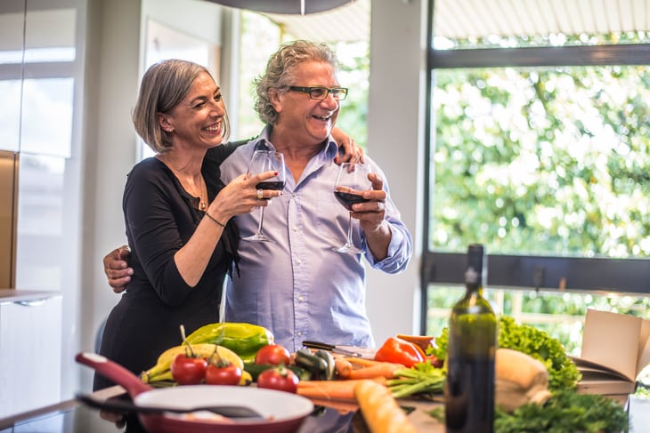 An older couple drinks wine