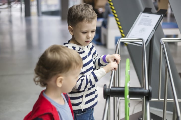 Two small children inspecting a science exhibit.
