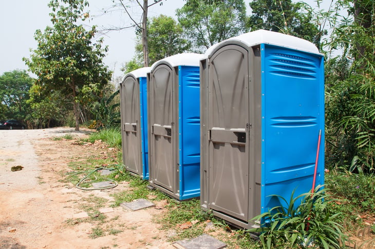 Three portable toilet units in a row.