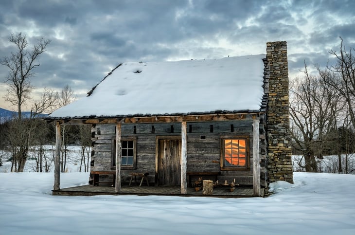 Old homestead house in snow.