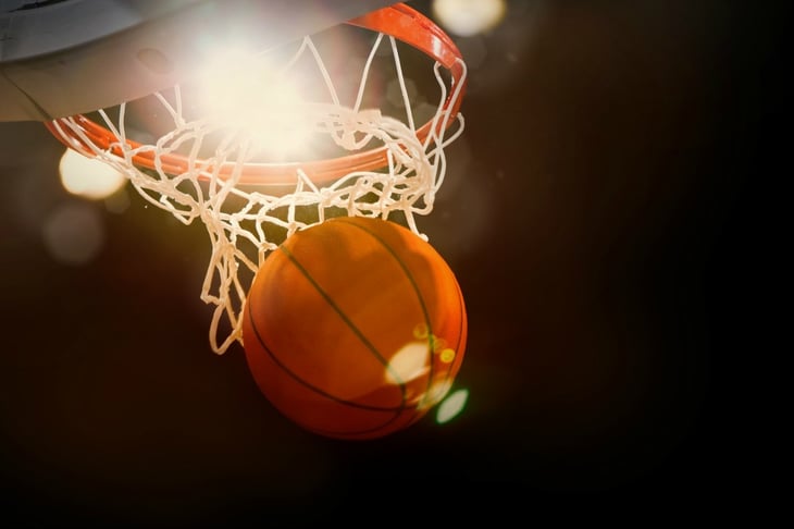 Basketball seen coming through the hoop.