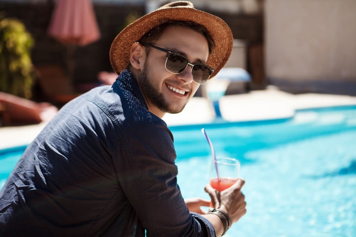 Man in sunglasses by swimming pool