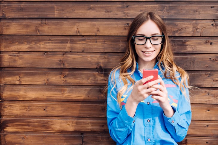 Young woman texting.