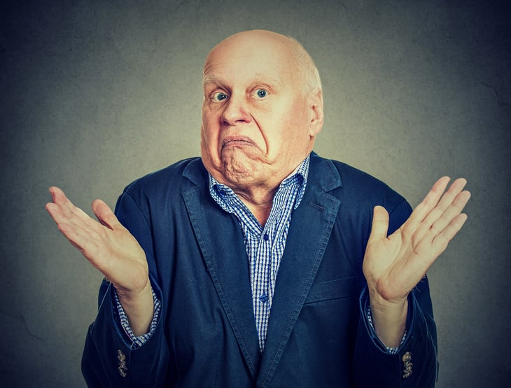 Older man shrugging shoulders in "I don't know" expression.
