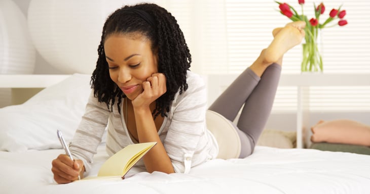 Woman writes in a journal