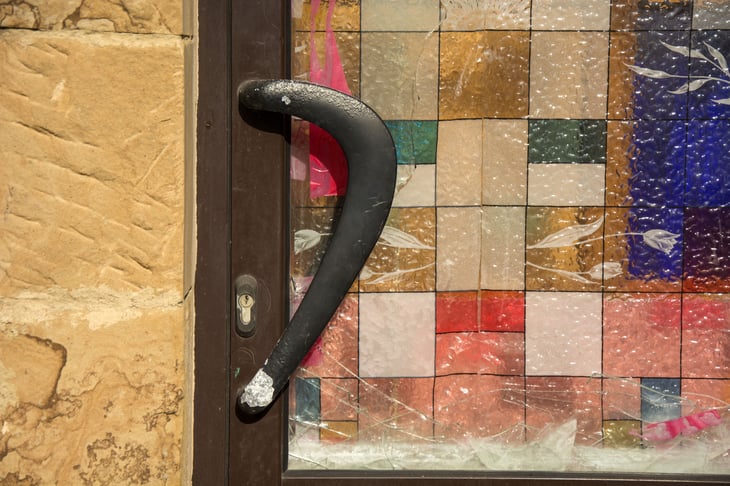 Unusual brass door handle with colored door.