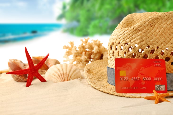 Credit card on beach with hat and starfish