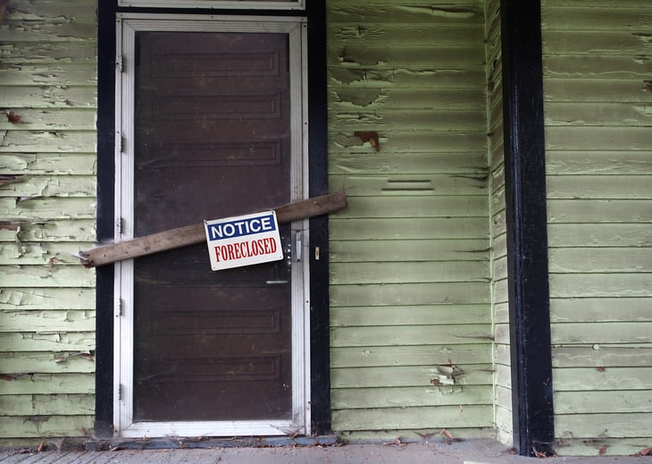 Door with "foreclosed" sign on it.