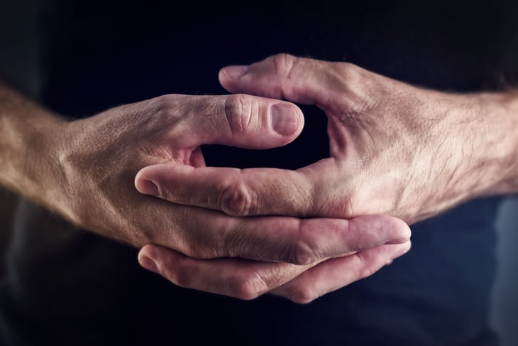 Mans hands twiddling thumbs.