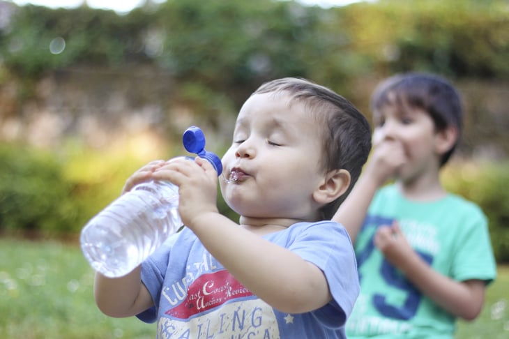 Small child drinking water.