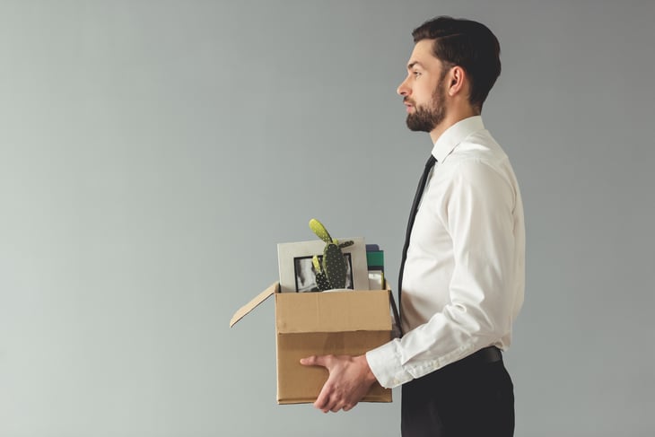 Businessman carrying a box of belongings