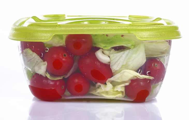 Vegetables in clear storage container.
