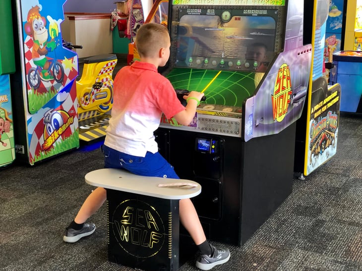 Boy plays video game at Chuck E. Cheese