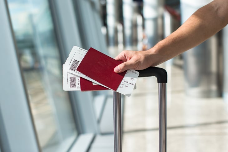 Traveler holding boarding passes and passports at the airport