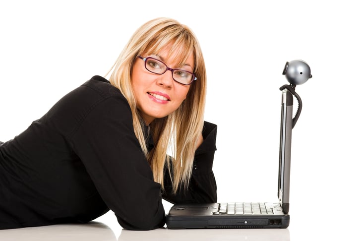 Woman with laptop and webcam.