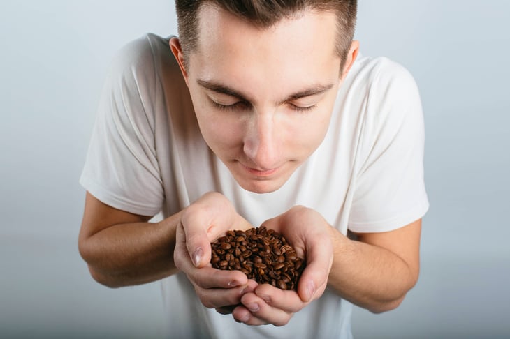 Man smelling coffee beans
