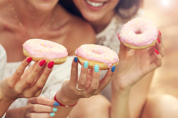 Happy people with frosted donuts