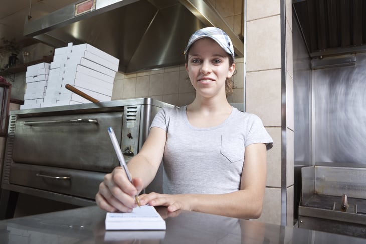 Young woman works in a fast food restaurant